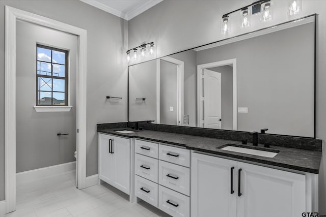 bathroom with vanity, toilet, and crown molding