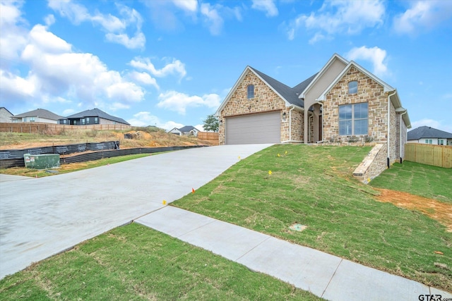 view of front facade with a front yard and a garage