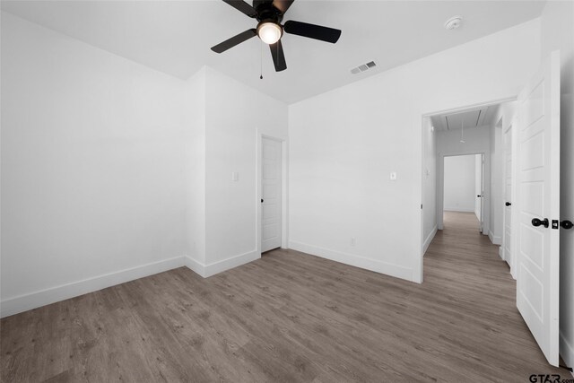 unfurnished room with hardwood / wood-style floors and ceiling fan