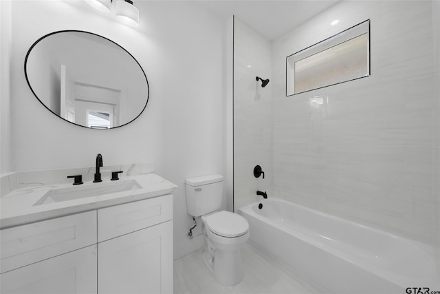 full bathroom with vanity, tiled shower / bath, and toilet