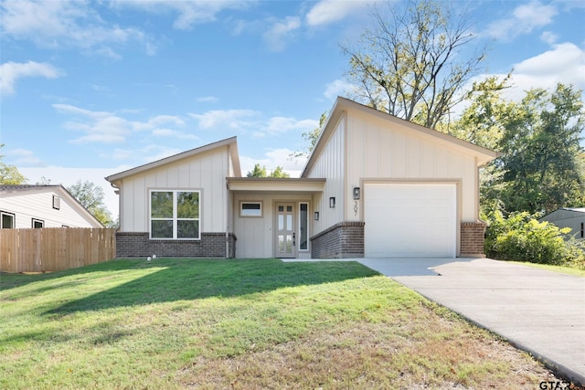 view of front of property featuring a garage and a front lawn