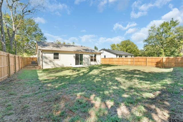 back of house with a lawn