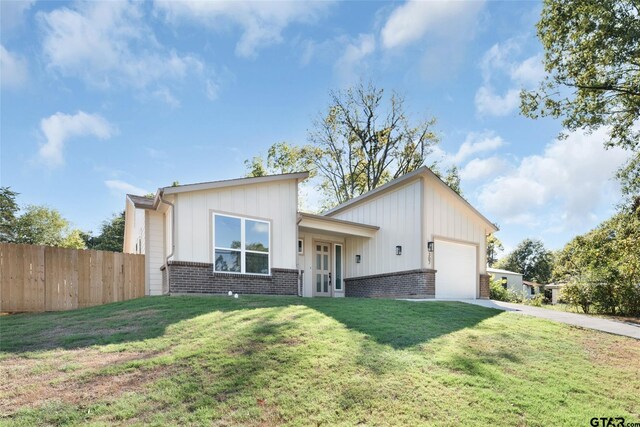 view of front of house with a garage and a front yard