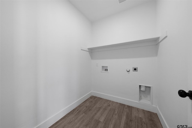 clothes washing area featuring washer hookup, wood-type flooring, hookup for a gas dryer, and hookup for an electric dryer