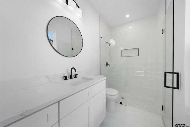 bathroom featuring walk in shower, vanity, and toilet