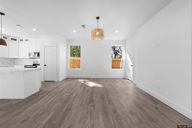 unfurnished living room with wood-type flooring