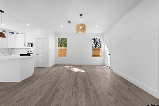 unfurnished living room with wood-type flooring