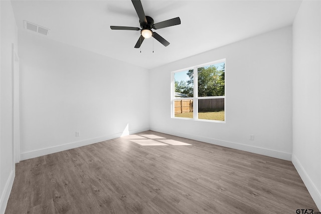 empty room featuring hardwood / wood-style flooring and ceiling fan