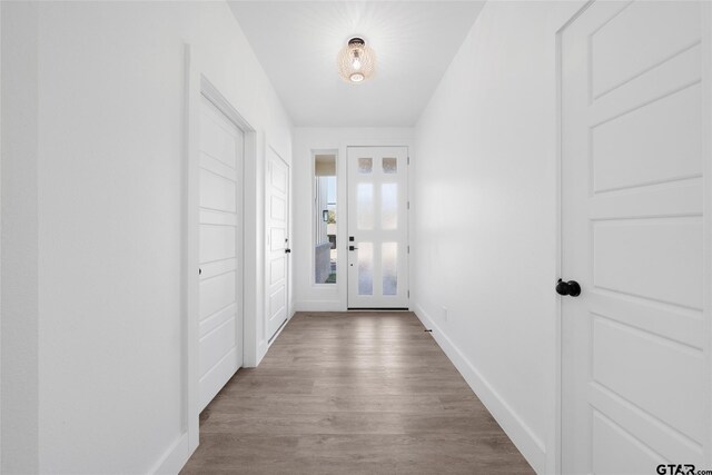 doorway to outside with hardwood / wood-style floors