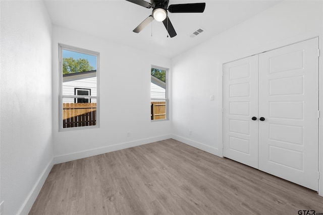 unfurnished bedroom with a closet, ceiling fan, and light hardwood / wood-style flooring