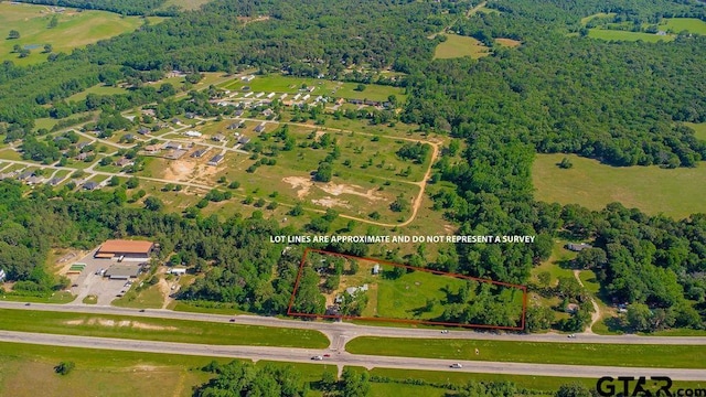 birds eye view of property with a forest view