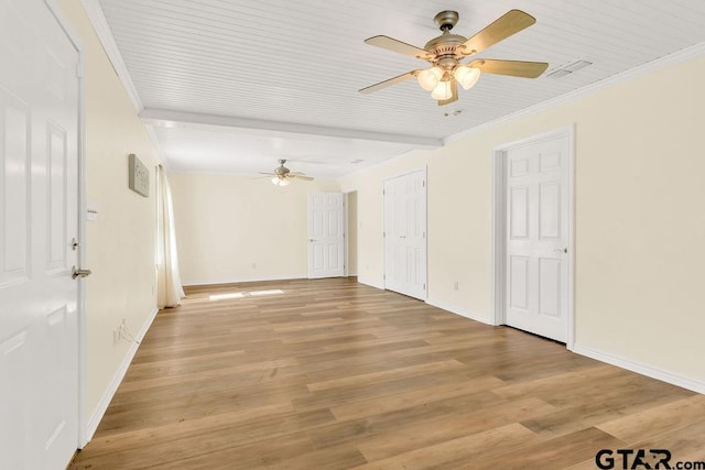 empty room with a ceiling fan, baseboards, and crown molding