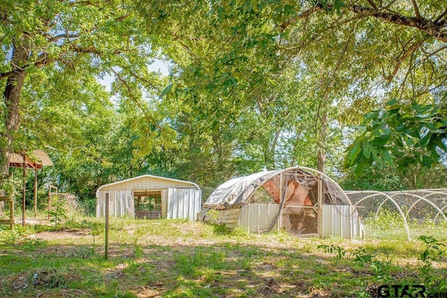 view of yard with an outdoor structure and fence
