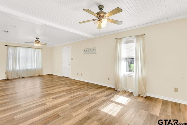 spare room with light wood-style flooring, baseboards, visible vents, ceiling fan, and ornamental molding