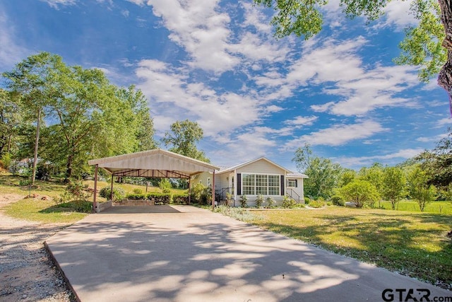 surrounding community featuring a lawn, driveway, and a carport