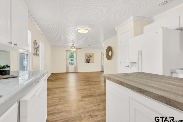 interior space with light wood finished floors, a ceiling fan, white appliances, crown molding, and white cabinetry