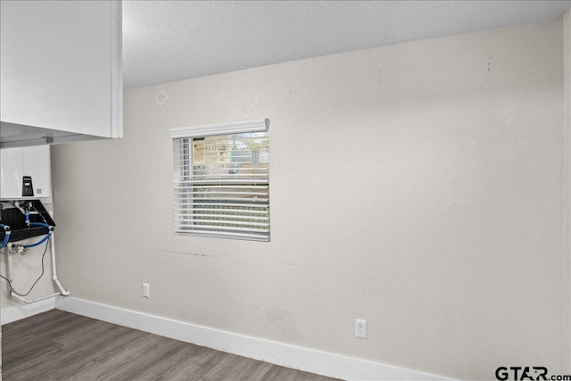 interior space featuring dark hardwood / wood-style flooring and a textured ceiling