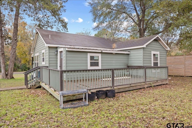 rear view of property with a lawn and a deck