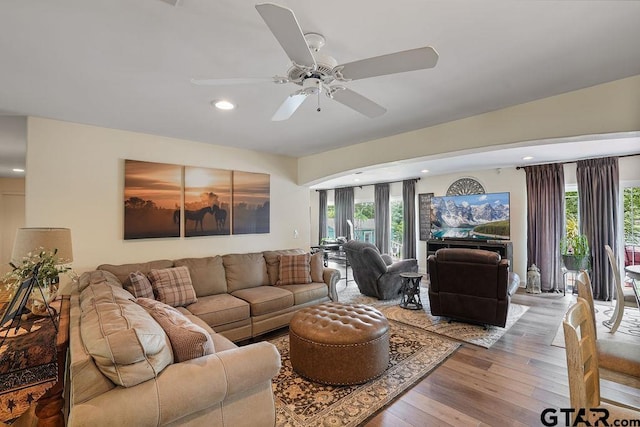 living room featuring wood-type flooring, recessed lighting, ceiling fan, and a healthy amount of sunlight