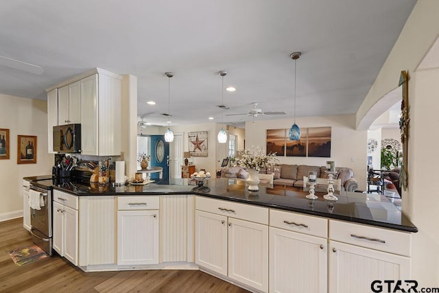 kitchen featuring ceiling fan, black microwave, light wood-style flooring, open floor plan, and stainless steel electric stove