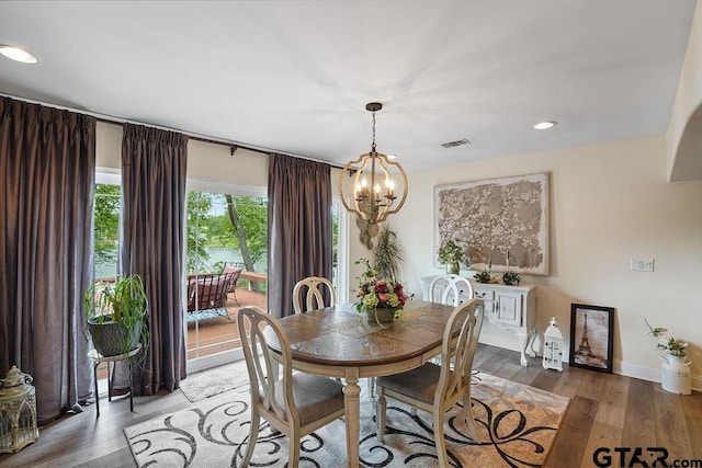 dining area with visible vents, recessed lighting, light wood-style flooring, and a chandelier