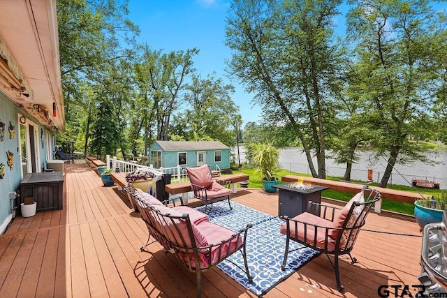 deck with an outbuilding and an outdoor fire pit