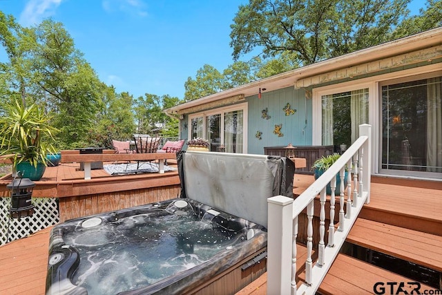 wooden deck with a hot tub