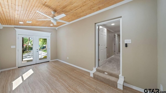 spare room with crown molding, ceiling fan, french doors, and wooden ceiling