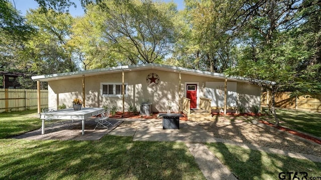 back of house with a lawn, a patio, and central AC unit