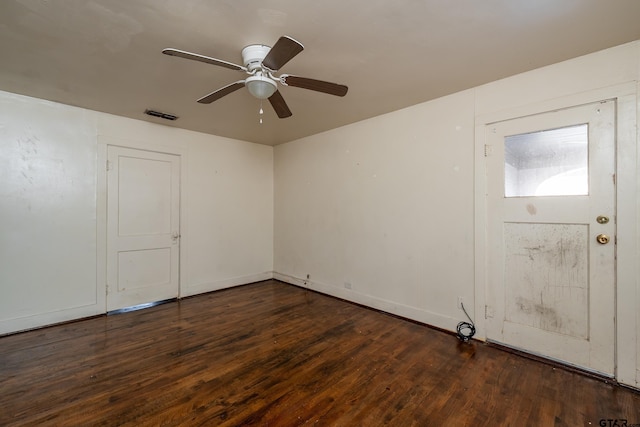 empty room featuring ceiling fan and dark hardwood / wood-style floors