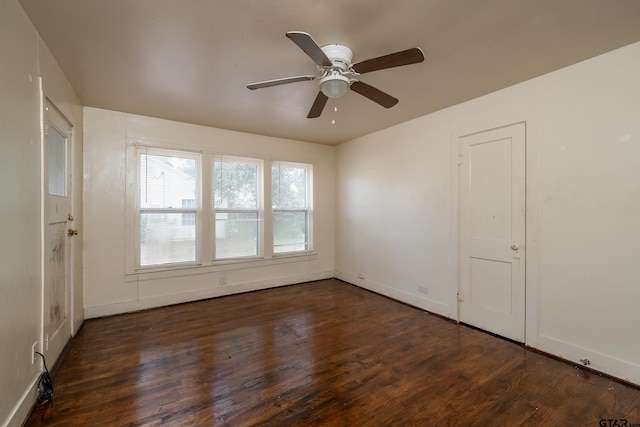 empty room featuring ceiling fan and dark hardwood / wood-style floors