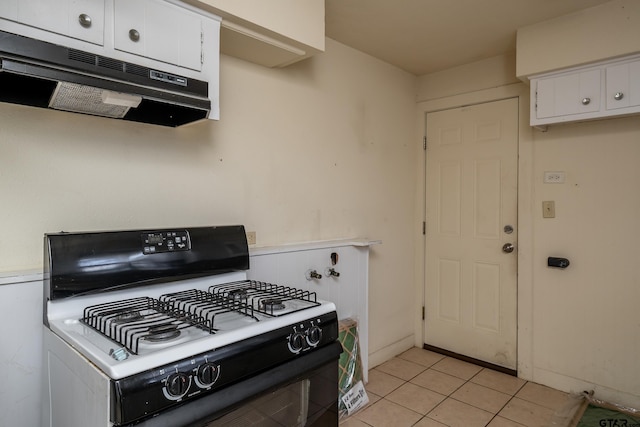 kitchen with white cabinetry, light tile patterned floors, and white range with gas stovetop