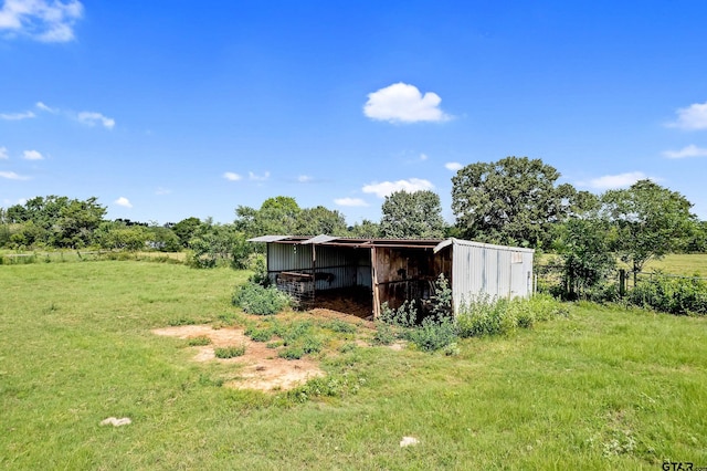 view of outbuilding featuring a yard and a rural view