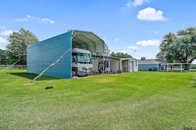 view of outdoor structure featuring a carport and a yard