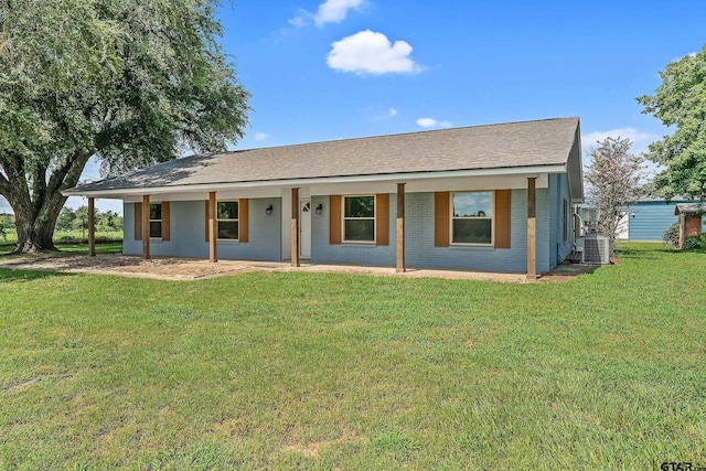 ranch-style home featuring a front lawn and central air condition unit