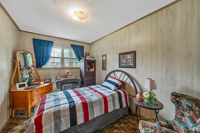 bedroom with a textured ceiling, crown molding, and wood walls