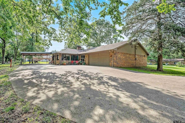 single story home featuring a garage and a carport