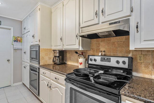 kitchen featuring backsplash, white cabinets, dark stone counters, and appliances with stainless steel finishes