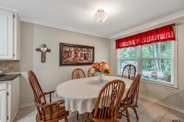 tiled dining area with crown molding and a textured ceiling