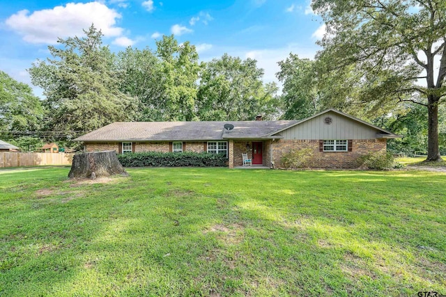 single story home with a front lawn