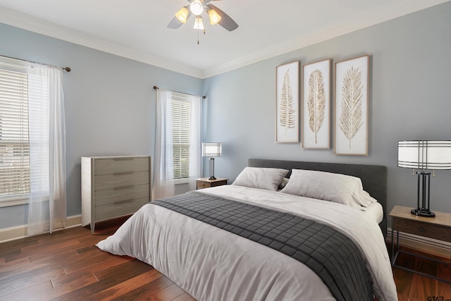 bedroom with ceiling fan, dark hardwood / wood-style floors, and ornamental molding