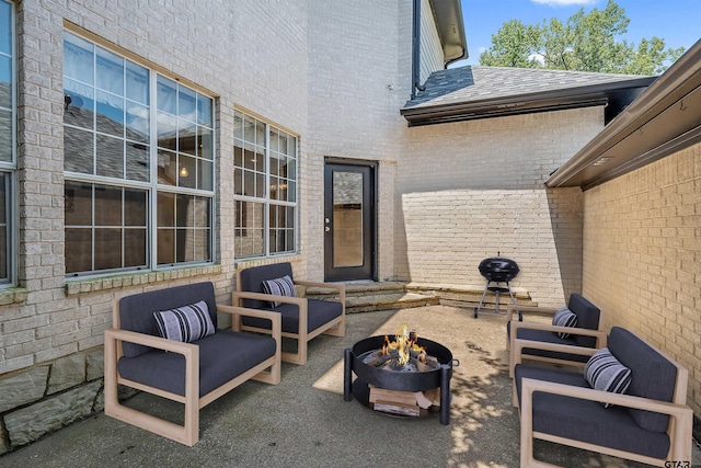 view of patio with an outdoor living space with a fire pit