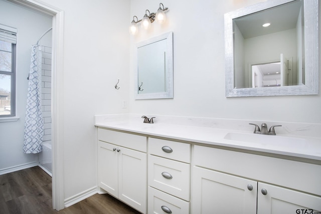 bathroom with vanity, wood-type flooring, and shower / bath combo with shower curtain