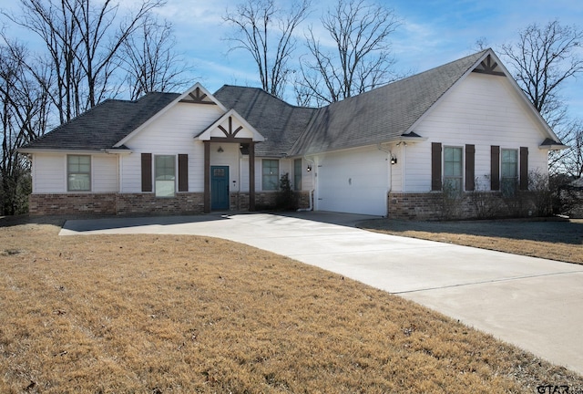 view of front of property with a garage and a front lawn