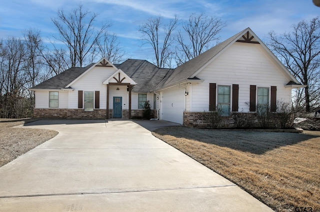 view of front of home featuring a garage and a front lawn