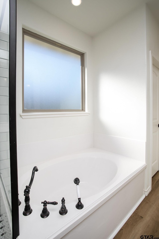 bathroom featuring hardwood / wood-style floors and a bathtub