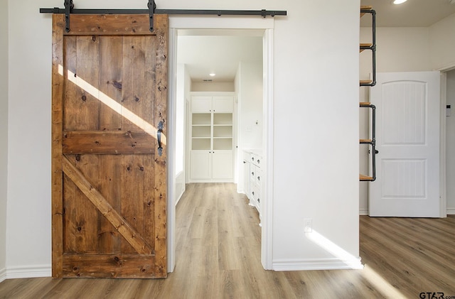 interior space featuring a barn door and light hardwood / wood-style floors