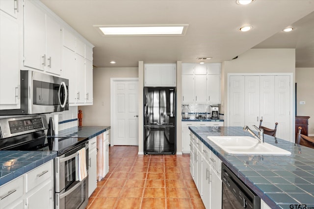 7016 Fm 3054, Malakoff, TX 75148 - kitchen with black appliances, tile countertops, a sink, backsplash, and white cabinets