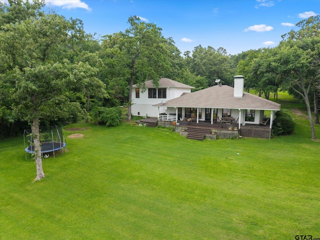 7016 Fm 3054, Malakoff, TX 75148 - rear view of house featuring a trampoline, a lawn, a chimney, and a shingled roof