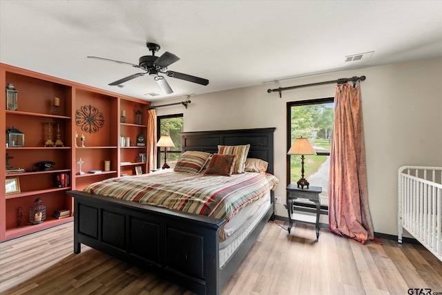 7016 Fm 3054, Malakoff, TX 75148 - bedroom featuring wood finished floors, ceiling fan, and radiator heating unit